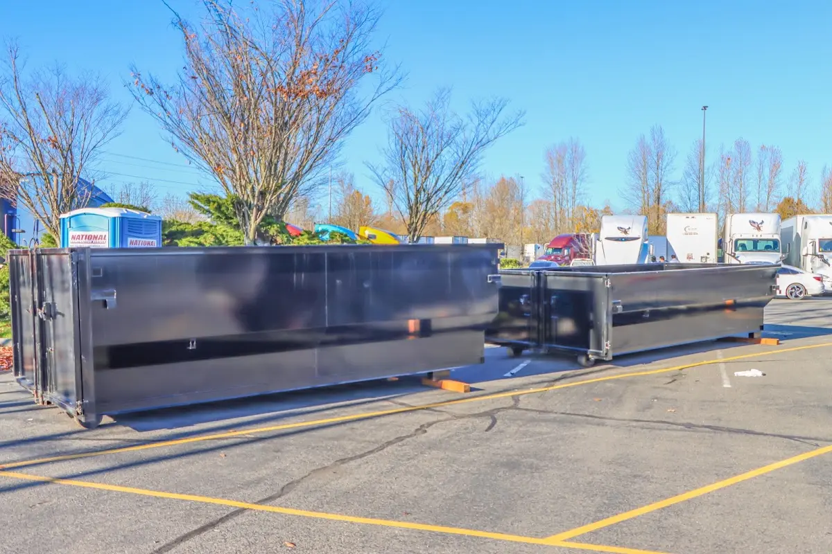 Professional dumpster rental service with roll-off container on residential driveway in Coxsackie